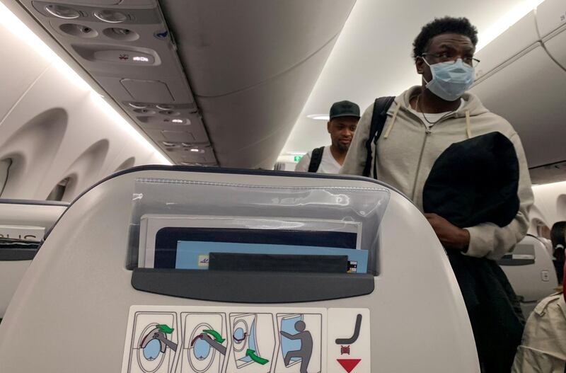 A passenger wears a protective mask on an EgyptAir flight from Cairo to Luxor, Egypt March 9, 2020. Reuters
