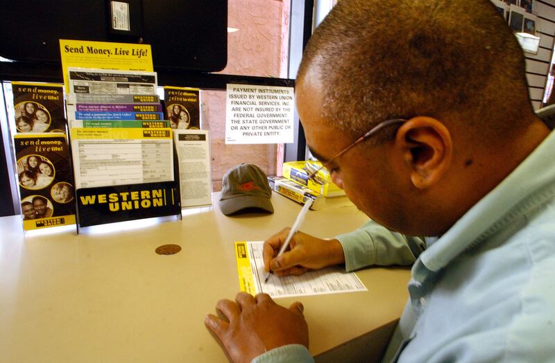 A man fills out a form to wire money at a Western Union outlet in San Diego, California. Getty Images