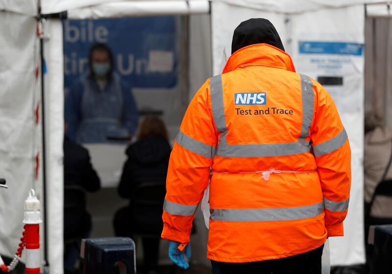 An NHS worker stands near a coronavirus disease mobile testing unit in Tower Hamlets, London. Reuters