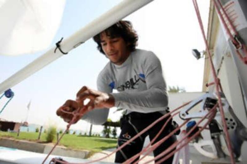 The UAE sailor Adel Khaled makes some last-minute adjustments as he prepares to sail his laser dinghy near the Emirates Sailing School off Al Samaliyahi Island.