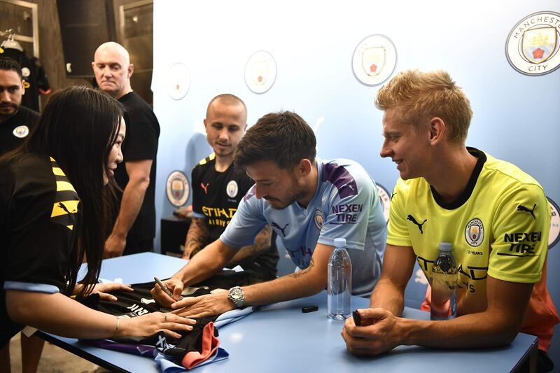 David Silva signs autographs for fans during a promotional event in Hong Kong. AFP