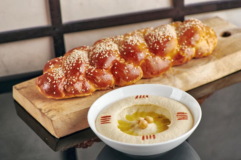 Challah, the classic braided bread, alongside a dish of hummus. Courtesy of Armani Hotel Dubai