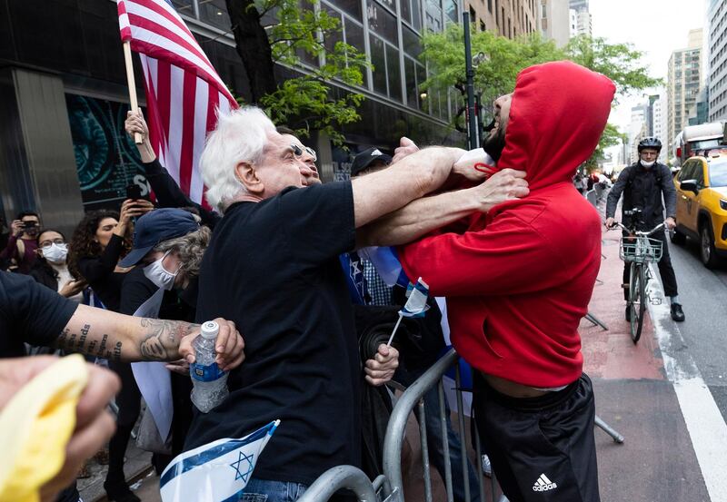 A pro-Palestinian protester scuffles with pro-Israel demonstrators during a rally near the Consulate General of Israel in New York. EPA