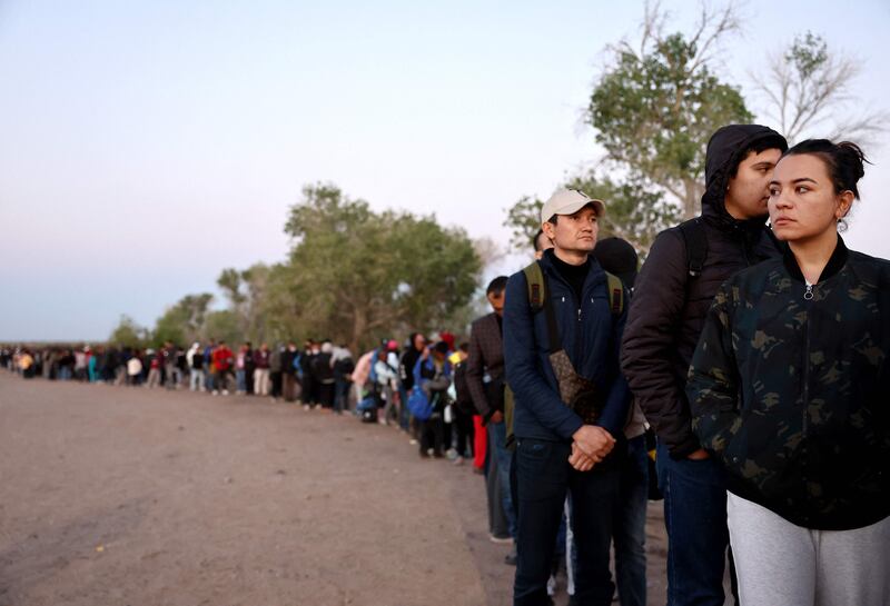 Migrants seeking asylum in the US queue before sunrise for processing after crossing into Arizona from Mexico. AFP