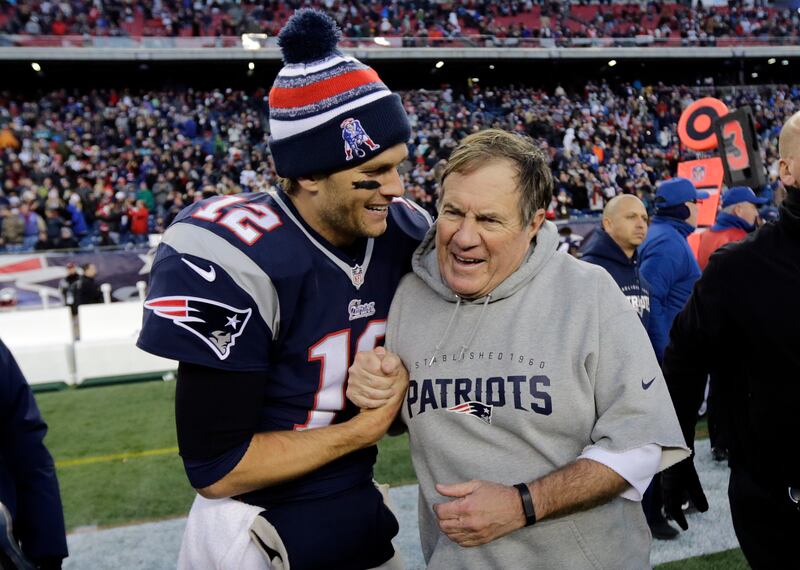 Patriots quarterback Tom Brady with head coach Bill Belichick after defeating the Miami Dolphins 41-13 in an NFL game in December 14, 2014. AP