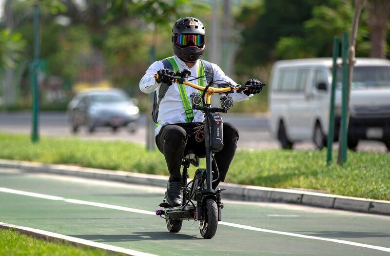 E-scooter riders are a common sight along the Corniche bicycle pathway in Abu Dhabi on May 5th, 2021. Victor Besa / The National.