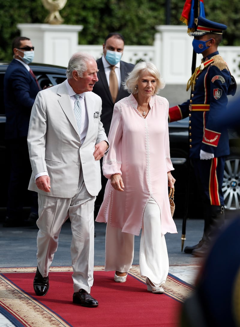 King Charles and the queen consort, who is wearing a light pink Anna Valentine outfit, arrive at the presidential palace in Cairo on November 18, 2021. Getty Images