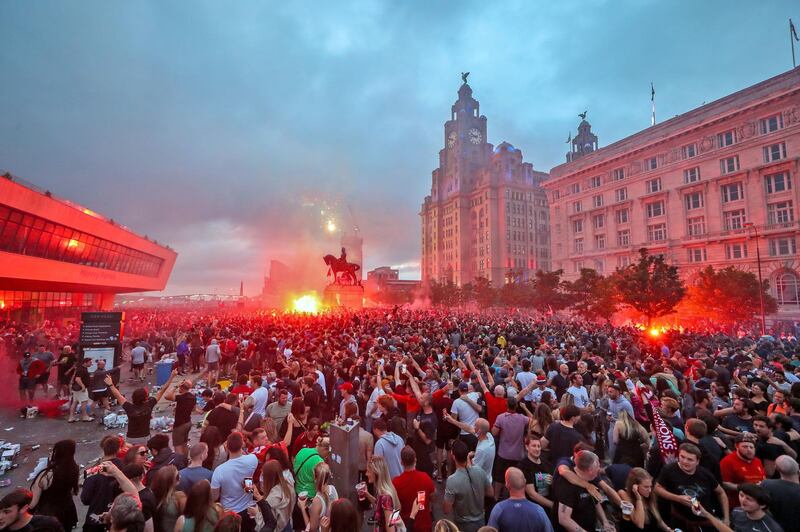 Liverpool fans let off flares outside the Liver Building in Liverpool. PA