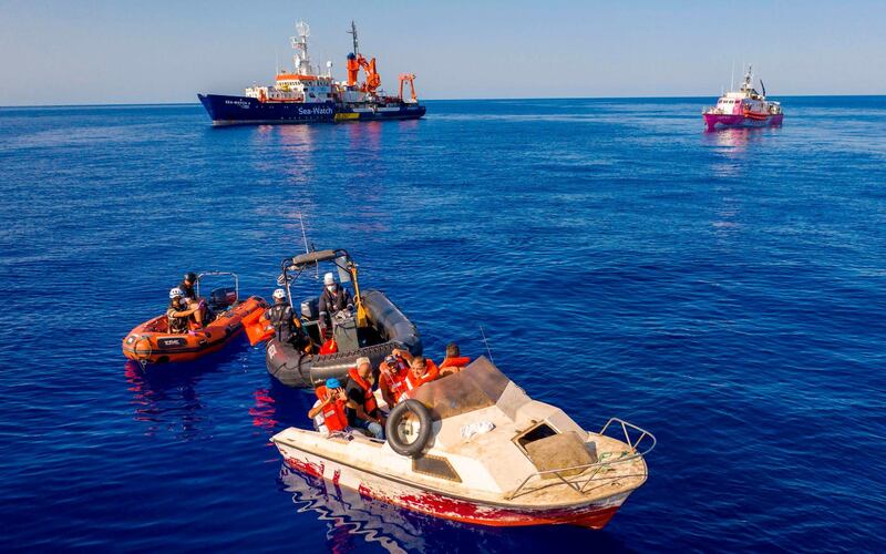 Three small rescue boats that are part of the Sea-Watch 4 civil sea rescue ship approching he pink rescue boat "Louise Michel" off the coast of Libya.  British street artist Banksy is funding the Louise Michel, covered with his own artwork, to rescue migrants in the Mediterranean. AFP