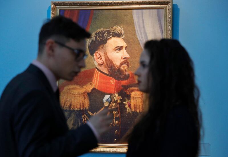 Visitors speak in front of a portrait of Argentina's Lionel Messi at the Museum of Academy of Arts in St.Petersburg, Russia. Dmitri Lovetsky / AP Photo