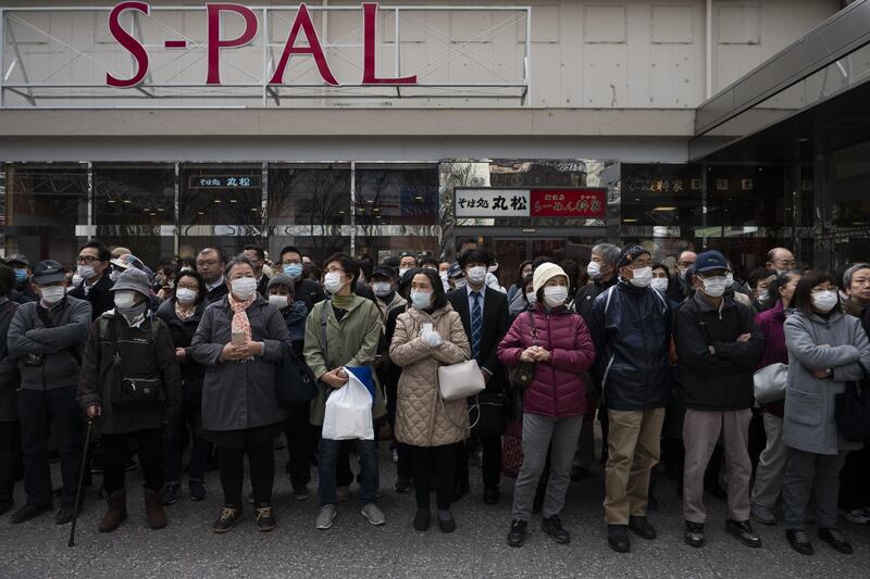 People gather to view the Olympic Flame in Fukushima City. AP