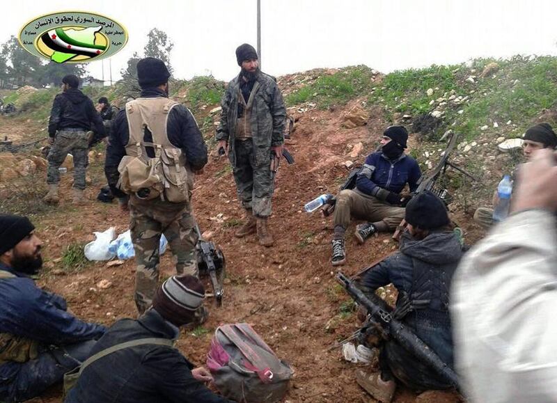 The two men are accused of being involved in a Qatar-based social networking site that raised a “significant” amount of funds for Jabhat Al Nusra, some of whose fighters are pictured here in northwestern Syrian. Syrian Observatory for Human Rights/AP Photo 