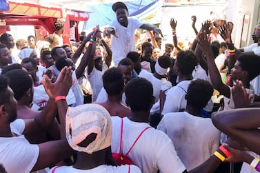 Migrants celebrate aboard the 'Ocean Viking' rescue ship as six EU countries agreed to take them in after 14 days at sea.. AFP