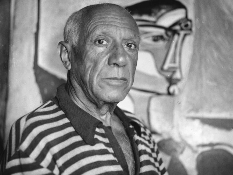 Pablo Picasso with one of his paintings at home in France, where he died in 1973. Getty Images