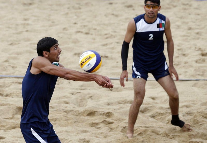 Afghanistan's Pardes Safi, left, and Mohammad Zaker, right, play a return during one of their preliminary matches in beach volleyball at the Asian Games. Olivia Harris / Reuters / September 24, 2014