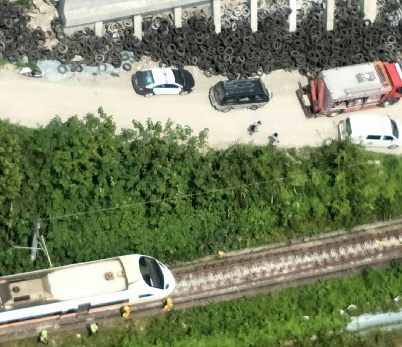 In this photo released by National Fire Agency, rescue vehicles are seen near the site of a partial train derailment in Toroko Gorge in Taiwan's eastern Hualien region. AP