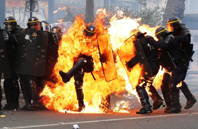 French CRS anti-riot police officers are engulfed in flames during May Day clashes in Paris.  Zakaria Abdelkafi / AFP Photo / May 1, 2017