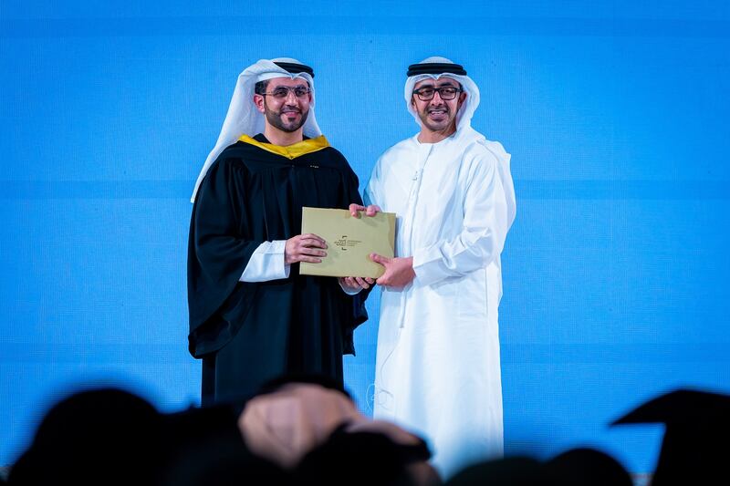 A student receives his degree certificate from Sheikh Abdullah. 