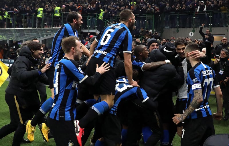 Inter Milan's Romelu Lukaku is mobbed by teammates after scoring against AC Milan. EPA