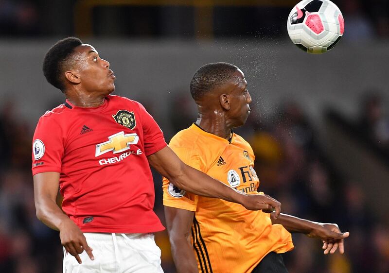 Manchester United's French striker Anthony Martial, left, goes up for a header with Wolves defender Willy Boly. AFP