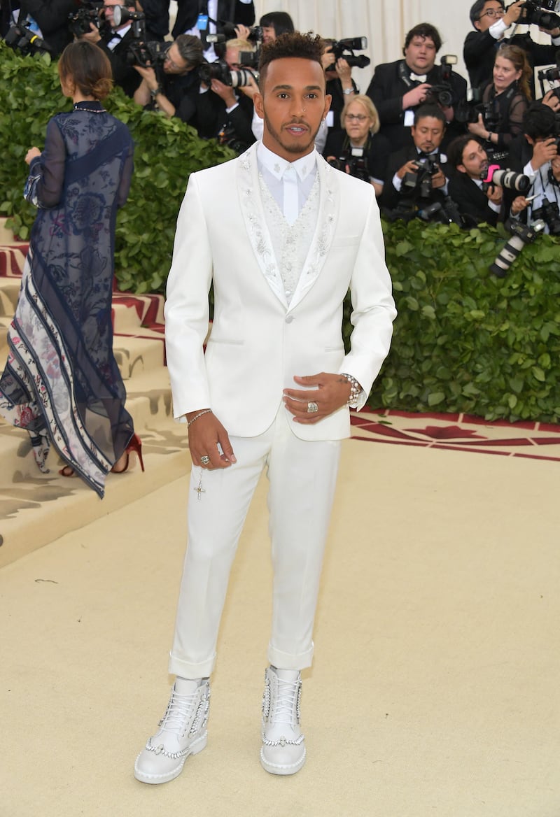 Lewis Hamilton, in a white Tommy Hilfiger suit, attends the Met Gala at the Metropolitan Museum of Art on May 7, 2018, in New York City. Getty Images