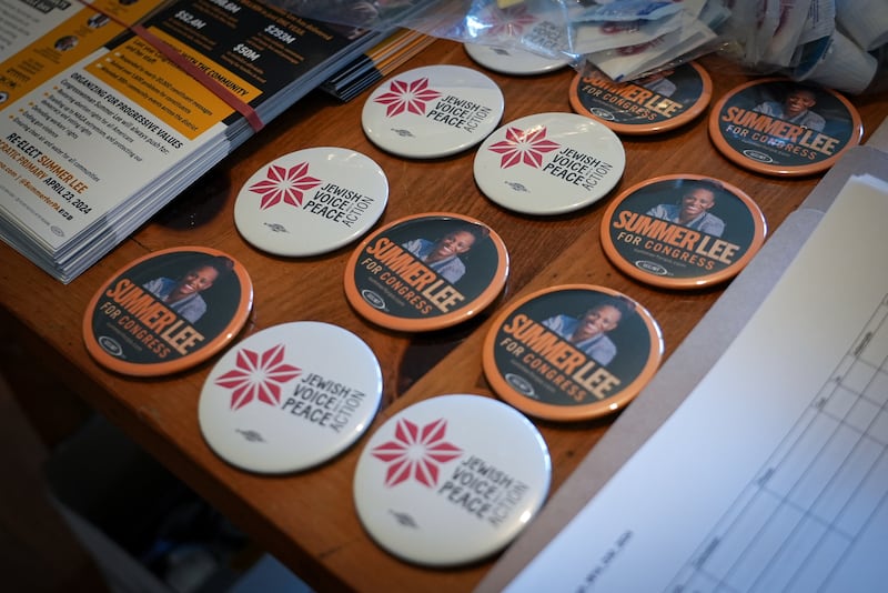 Badges and pamphlets supporting Ms Lee are laid out for distribution