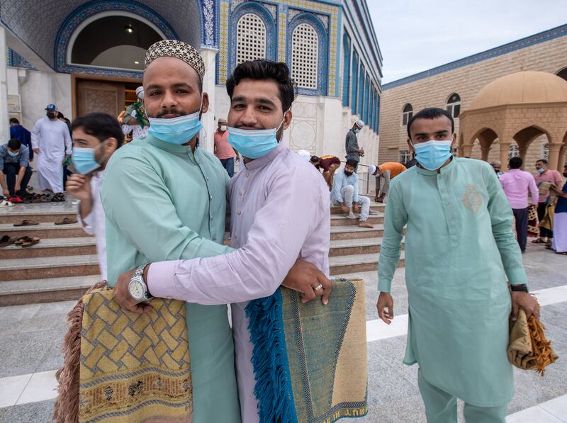 Worshippers embrace after morning prayers in Abu Dhabi. Victor Besa / The National