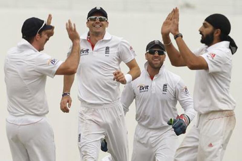 England's Monty Panesar, right, celebrates with his teammates Matt Prior, second right, James Anderson, second left, captain Andrew Strauss, left, taking the wicket during the fourth day of their second cricket test match of a three-match series against Pakistan at Zayed Cricket Stadium in Abu Dhabi, United Arab Emirates, Saturday, Jan. 28, 2012. (AP Photo/Hassan Ammar)