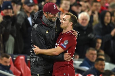 Liverpool's German manager Jurgen Klopp chats with Liverpool's Swiss midfielder Xherdan Shaqiri (R) as he's substituted during the UEFA Champions League group C football match between Liverpool and Red Star Belgrade at Anfield in Liverpool, north west England on October 24, 2018.  / AFP / Oli SCARFF                          
