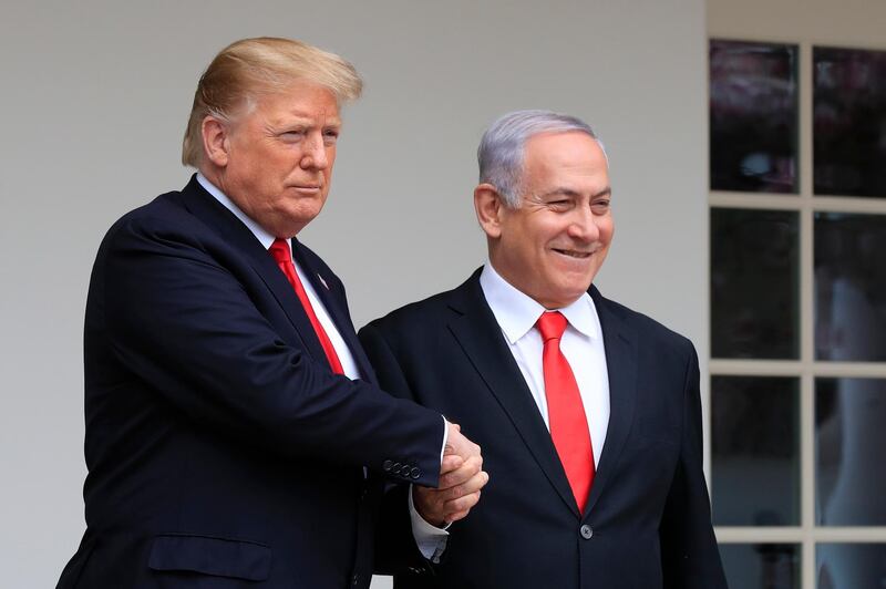 FILE - In this March 25, 2019 file photo, President Donald Trump welcomes visiting Israeli Prime Minister Benjamin Netanyahu to the White House in Washington.  Netanyahu, locked in a razor tight race and facing the likelihood of criminal corruption charges, a decisive victory in Tuesday, Sept. 17, vote may be the only thing to keep him out of the courtroom.  (AP Photo/Manuel Balce Ceneta, File)