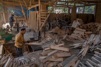 Kashmiri workers prepare cricket bats inside a factory in Awantipora. AP Photo