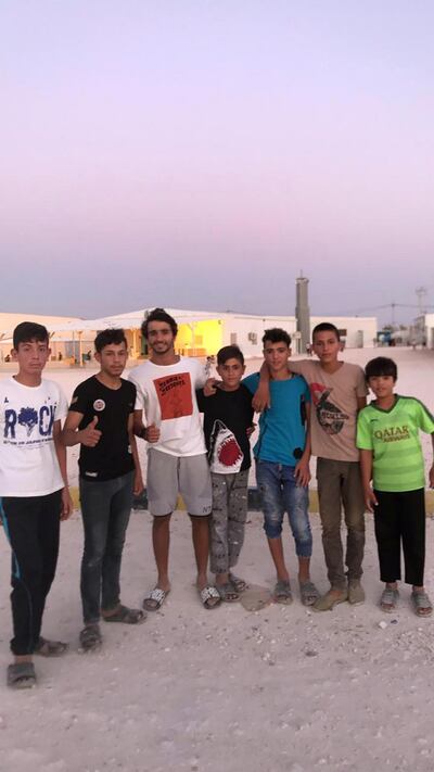 Abdulla Al Hashimi - third from right – with refugees at the the UAE-run Mrajeeb Al Fhood camp in Jordan