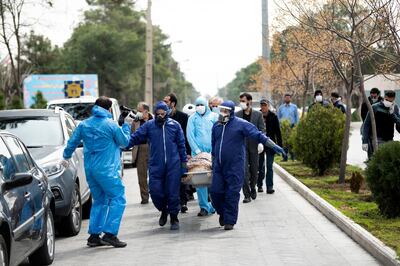 FILEâ€” In this Sunday, March 8, 2020 file photo, men wearing protective gear carry the body of Fatemeh Rahbar, a lawmaker-elect from Tehran constituency, who died on Saturday after being infected with the new coronavirus, at Behesht-e-Zahra cemetery, just outside Tehran, Iran. Nine out of 10 cases of the virus in the Middle East come from the Islamic Republic. For most people, the new coronavirus causes only mild or moderate symptoms. For some it can cause more severe illness. (Mehdi Khanlari/Fars News Agency via AP, File)
