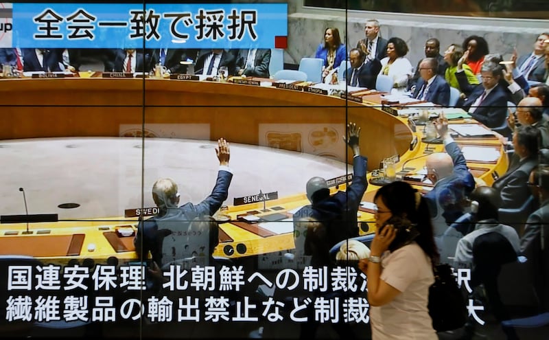 epa06199118 A pedestrian walks in front of a huge display showing a TV news program reporting on the UN Security Council session in Ne York that agreed on sanctions against North Korea, in Tokyo, Japan, 12 September, 2017. The United Nations Security Council on 12 September 2017 agreed on tough sanctions against North Korea following another recent nuclear test of what the country's regime said was a hydrogene bomb, and other violations of earlier UN resolutions such as repeated tests for ballistic missiles and continuing their nuclear program.  EPA/KIMIMASA MAYAMA