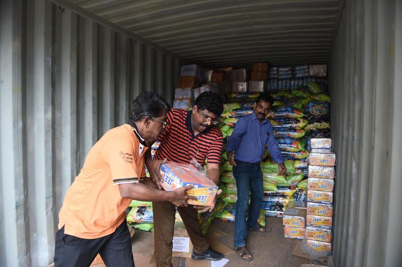 Indian volunteers from the Haridwar Mitra Mandal Charitable Trust load aid packets to be shipped to flood-hit Kerala, in Ahmedabad. AFP
