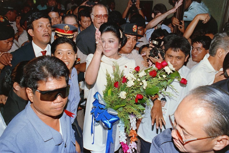 Imelda Marcos, accompanied by her son Ferdinand 'Bongbong' Marcos Jr, returns to the Philippines in 1991 to face charges of raiding the country's coffers. AFP