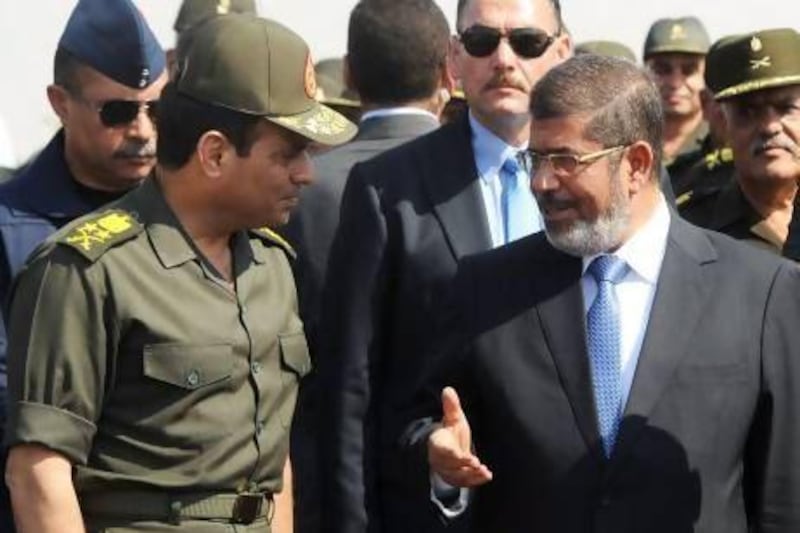 Egypt's president Mohammed Morsi (right) speaks with his defence minister, General Abdel Fattah El Sisi, during a visit to the 6th Armoured Division near Ismailia on October 10.