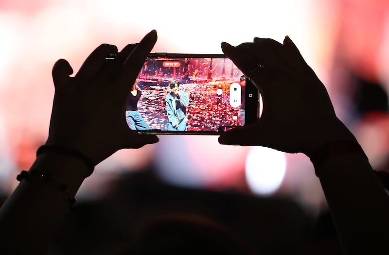 A fan takes an up-close photo of Chanyeol while he performs