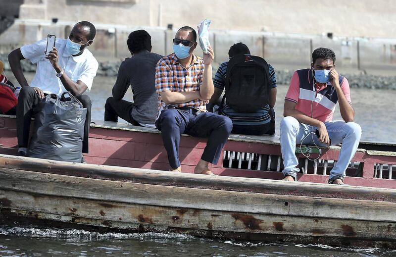 DUBAI, UNITED ARAB EMIRATES , July 2– 2020 :- People wearing protective face mask on the Abra in Dubai Creek in Dubai. (Pawan Singh / The National) For News/Standalone/Online/Stock