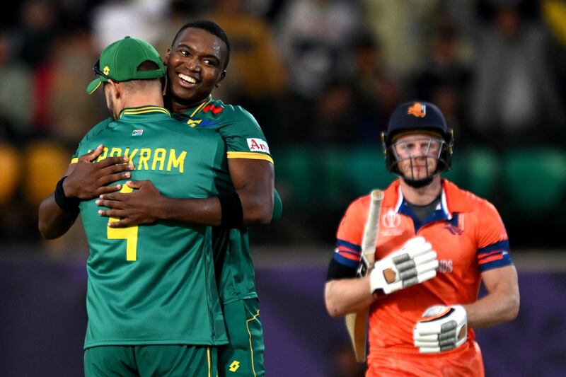 South Africa's Lungi Ngidi celebrates with teammate Aiden Markram after taking the wicket of the Netherlands' Sybrand Engelbrecht. AFP