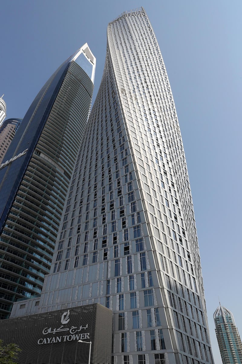 DUBAI , UNITED ARAB EMIRATES , October 28  – 2019 :- Exterior view of the Cayan Tower in Dubai Marina  in Dubai. Lot of residents are facing building issues due to outstanding service charges by landlords.  ( Pawan Singh / The National )  For News. Story by Kelly Clarke