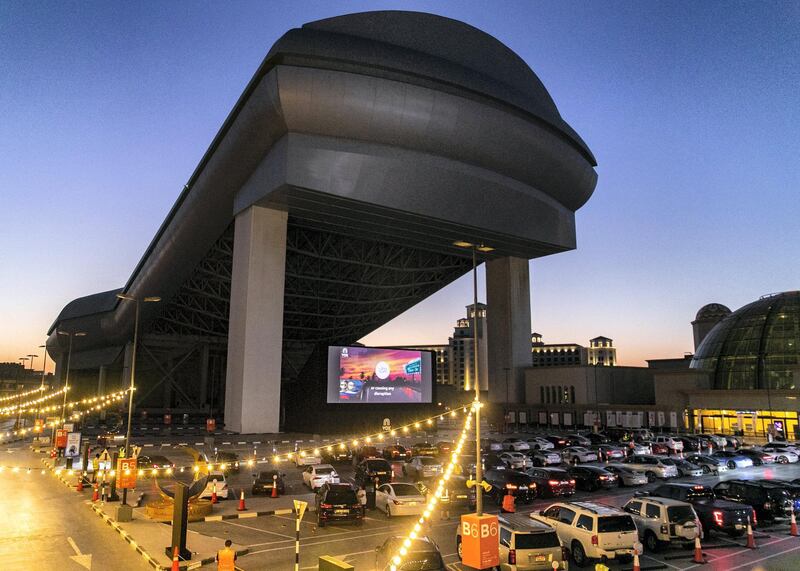 DUBAI, UNITED ARAB EMIRATES. 13 MAY 2020. 
The drive-in cinema is making a comeback at Mall Of The Emirates, as the property and VOX Cinemas take the movie-going experience outdoors.

With social distancing measures keeping traditional theatres closed for the foreseeable future, a large screen has been assembled in the shopping centre's upper parking lot (level 3 near Ski Dubai) in front of which patrons will be able to take position, switch off their engines and settle in for some silver screen action all while observing sensible practices to combat the COVID-19 pandemic.  

(Photo: Reem Mohammed/The National)

Reporter:
Section: