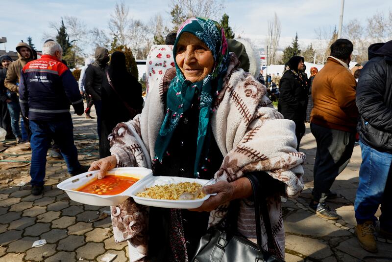 A woman carries a box of food in Kahramanmaras, Turkey. Reuters