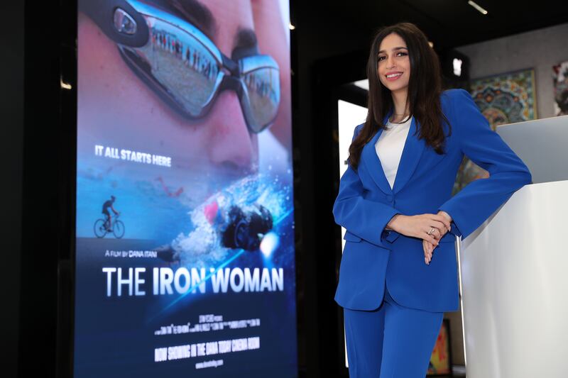 Dubai resident and filmmaker Dana Itani with the poster of her film The Iron Woman at Mall of the Emirates. Pawan Singh / The National