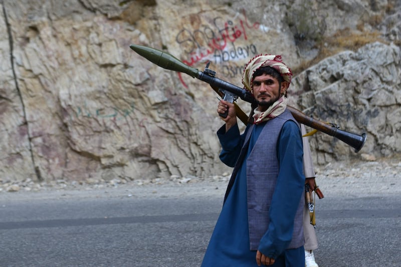 A fighter for anti-Taliban forces patrols along a road in Rah-e Tang, Panjshir province. AFP