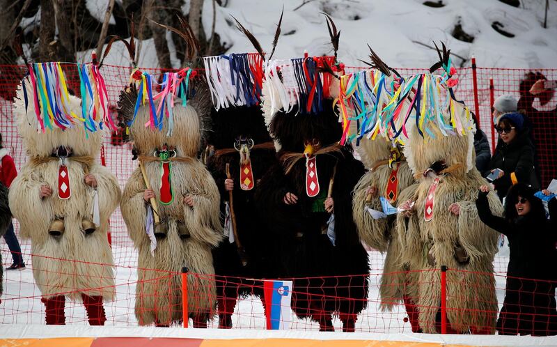 Slovenian fans dressed as the kurent, a traditional Slovenian carnival figure, watch the women's combined slalom at the 2018 Winter Olympics in Jeongseon, South Korea. Christophe Ena / AP Photo