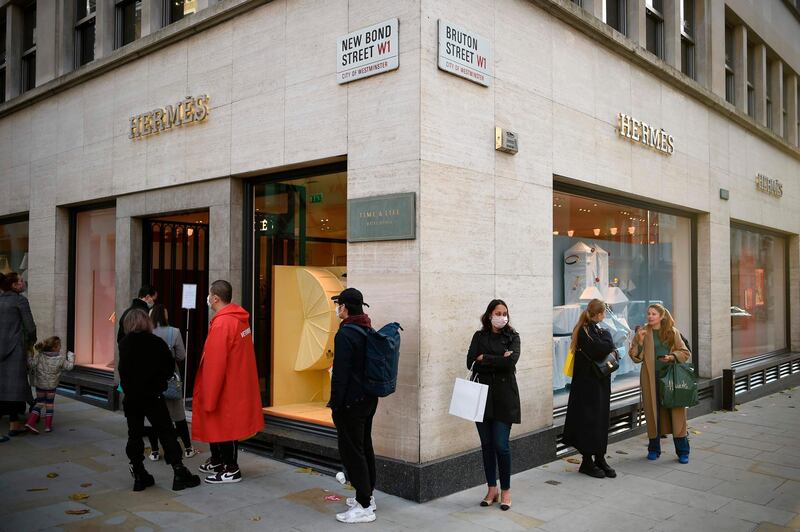 Shoppers queue to enter a branch of the luxury fashion retailer Hermes in central London. AFP