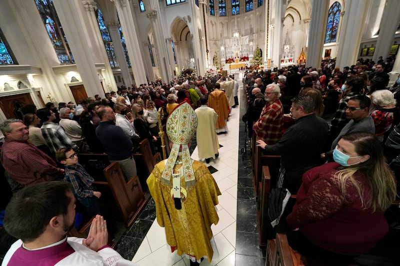 Most Rev Samuel J Aquila, archbishop of the archdiocese of Denver, heads down the aisle to say Christmas Eve Mass in the Cathedral Basilica of the Immaculate Conception in downtown Denver, Colorado. AP