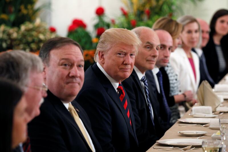 U.S. President Donald Trump flanked by Secretary of State Mike Pompeo and White House Chief of Staff John Kelly attend a lunch with Singapore's Prime Minister Lee Hsien Loong and officials at the Istana in Singapore June 11, 2018.  REUTERS/Jonathan Ernst