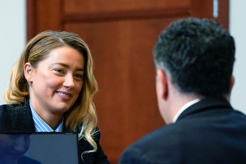 Heard speaks with her lawyer in the courtroom. Pool Photo via AP